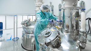 Pharmaceutical technician in sterile environment at pharmacy industry